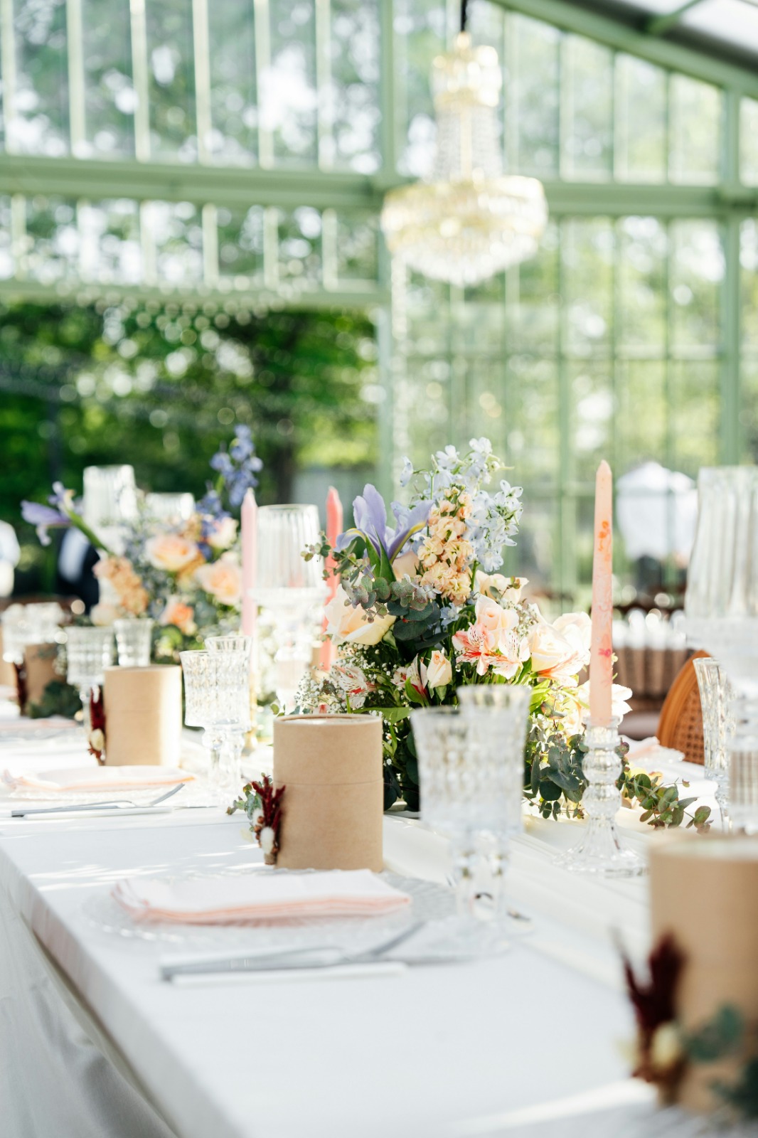 Elegant event table setting with floral arrangements and candles